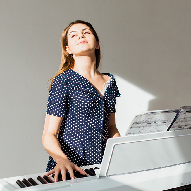 A student enjoying creative summer piano learning